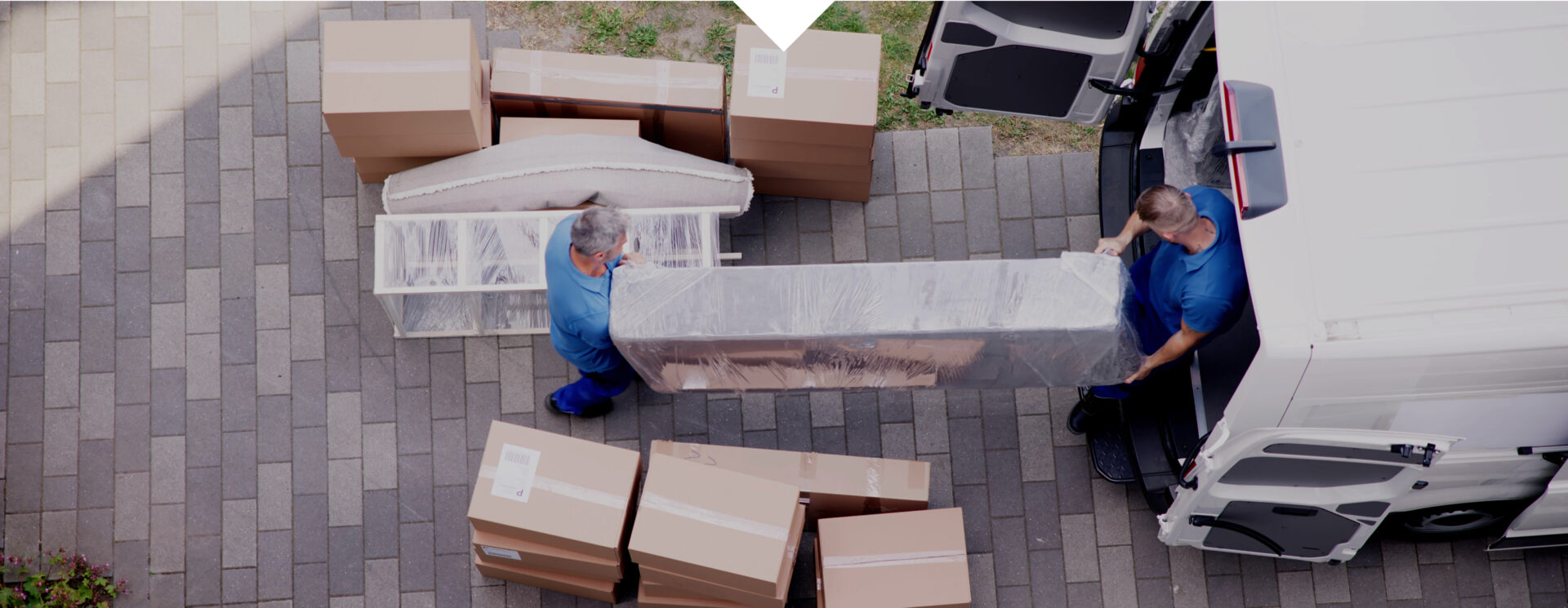 Movers unloading furniture and boxes from van.