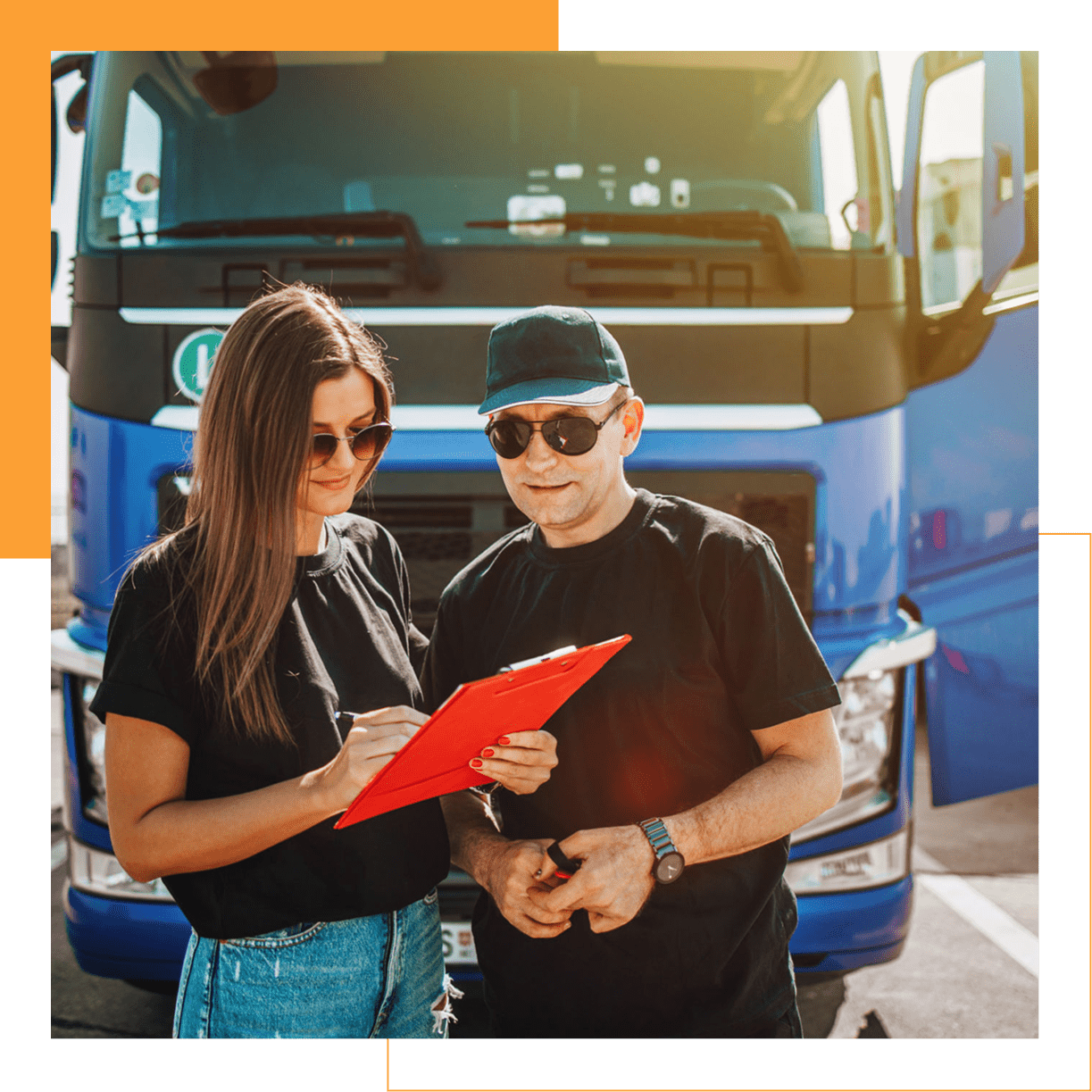 Two people in front of blue truck.